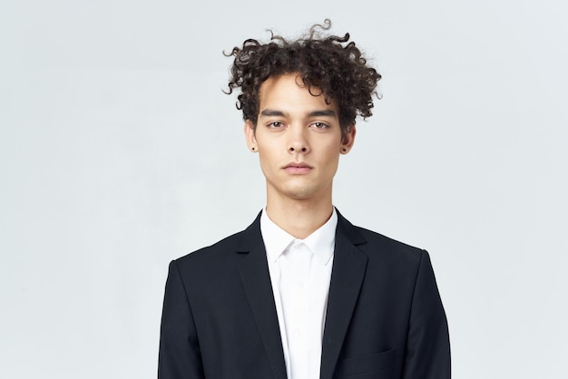 Business man with curly hair in suit black blazer studio