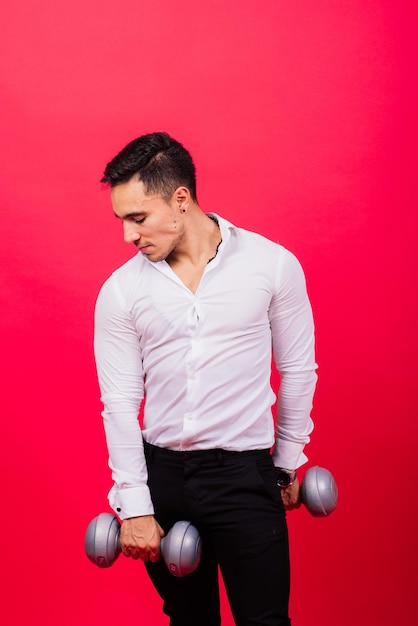 Business man with fitness dumbbells wear shirt studio shooting on red background