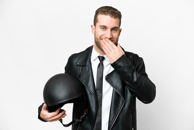 Business man with a motorcycle helmet over isolated white background happy and smiling covering mouth with hand