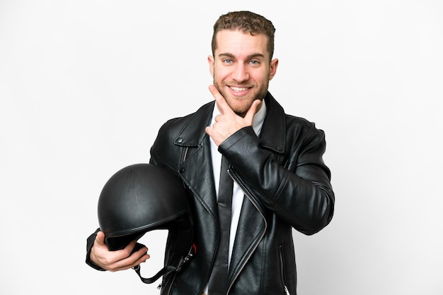 Business man with a motorcycle helmet over isolated white background happy and smiling