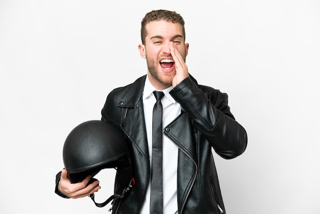 Business man with a motorcycle helmet over isolated white background shouting with mouth wide open