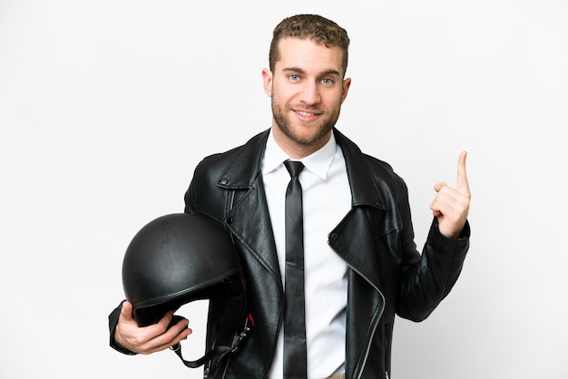 Business man with a motorcycle helmet over isolated white background showing and lifting a finger in sign of the best