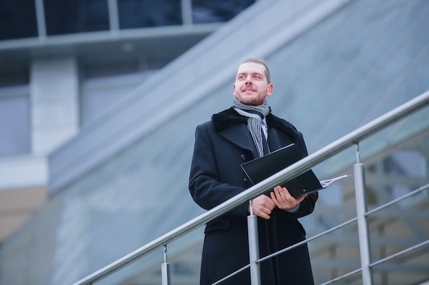 Business man with papers comes into his office