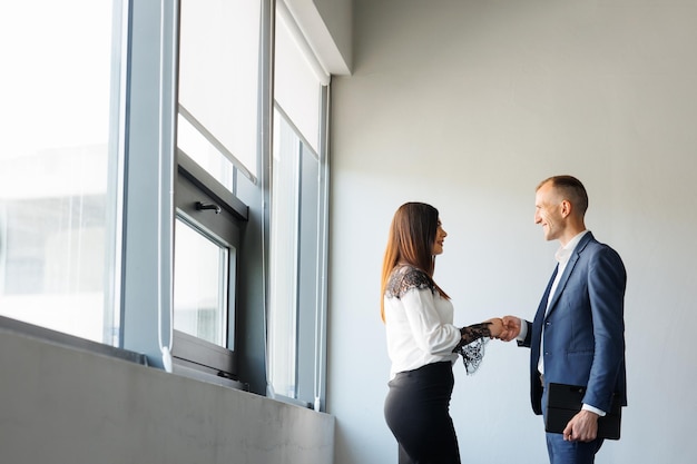 Business man and woman meeting business people handshaking