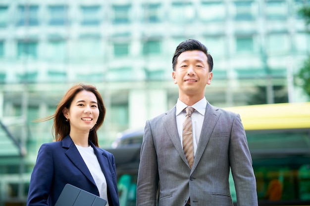 Business man and woman standing outdoors