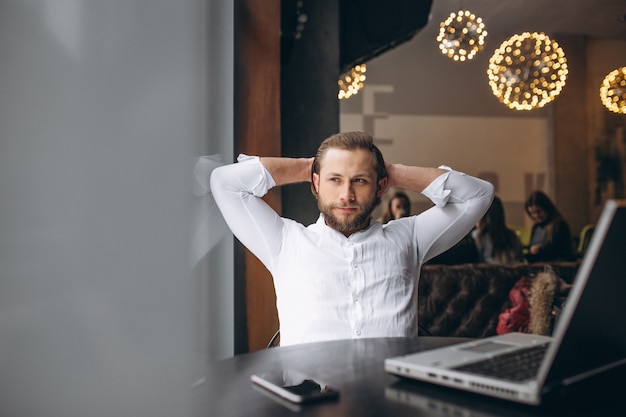 Business man working on computer in a cafe