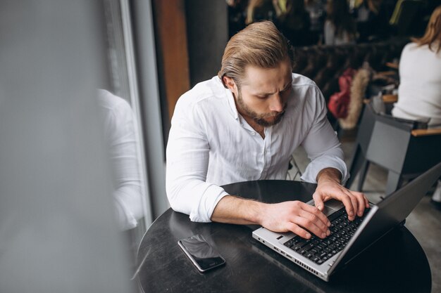 Business man working on computer in a cafe