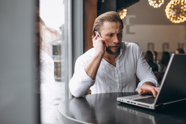 Business man working on computer in a cafe