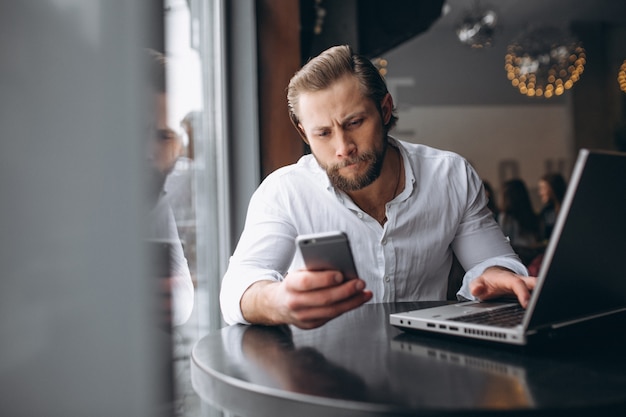 Business man working on computer in a cafe