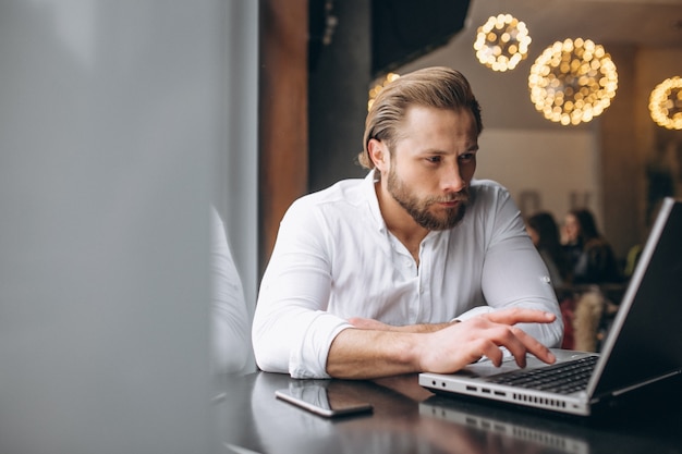 Business man working on computer in a cafe