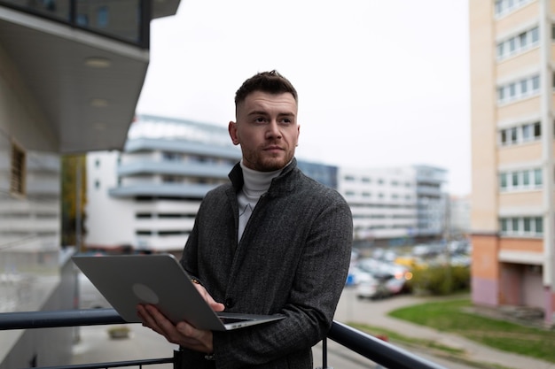 Business man working on laptop outside the office