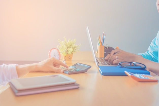 Business man working at office with digital tablet and documents on his desk