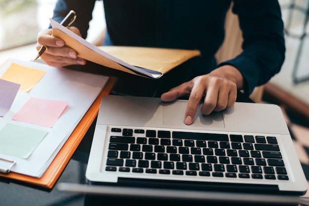 Business man working at office with documents and laptop on his desk financial adviser analyzing data