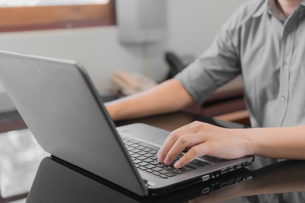 Business man working with the labtop at the office. Business working Concept.