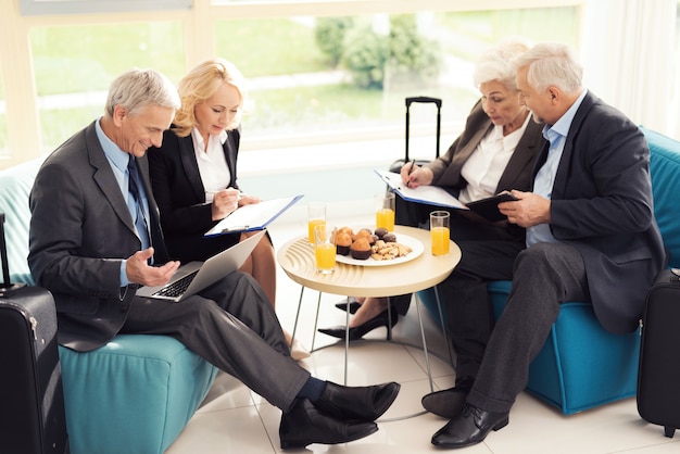 Business meeting in the airport hall.