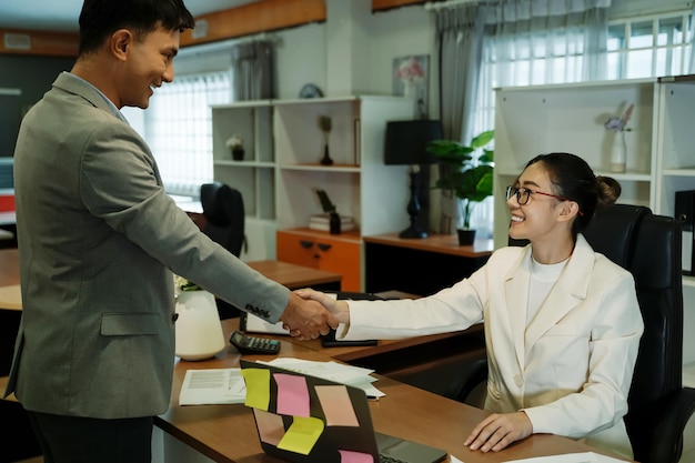 Business men and women shaking hands