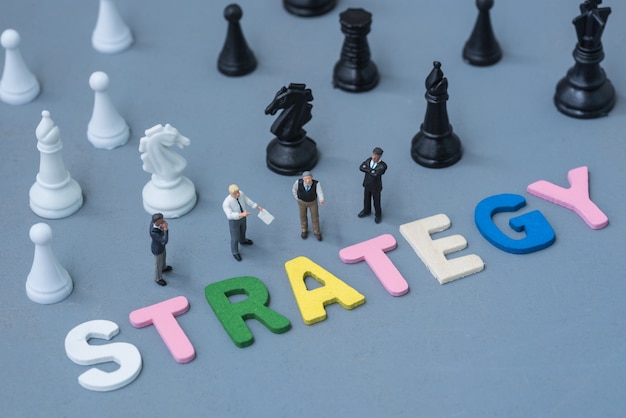 Photo business miniature make agreement with wood text strategy and chess background