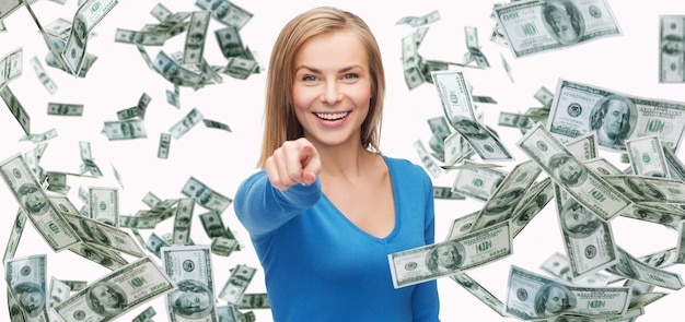 business, money, finance, people and banking concept - smiling woman with dollar cash money pointing finger on you