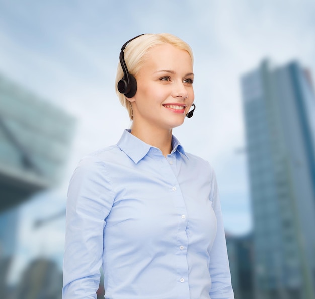 business and office concept - friendly female helpline operator with headphones