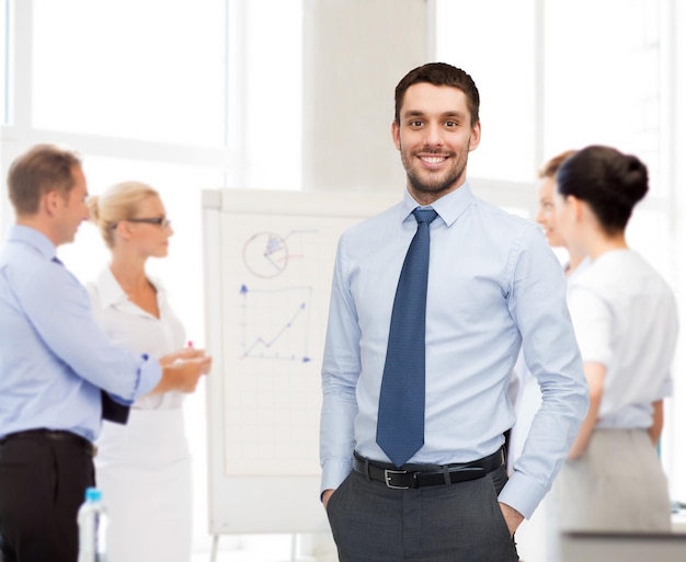 business, office and people concept - group of smiling businessmen with smartboard in office