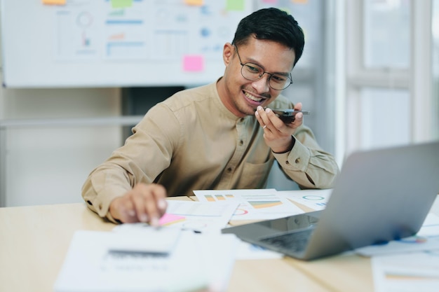 Business owner or Asian male marketers are using business phones calculator and computers to do office work