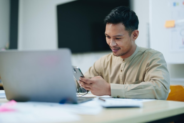 Business owner or Asian male marketers are using business phones and computers to do office work