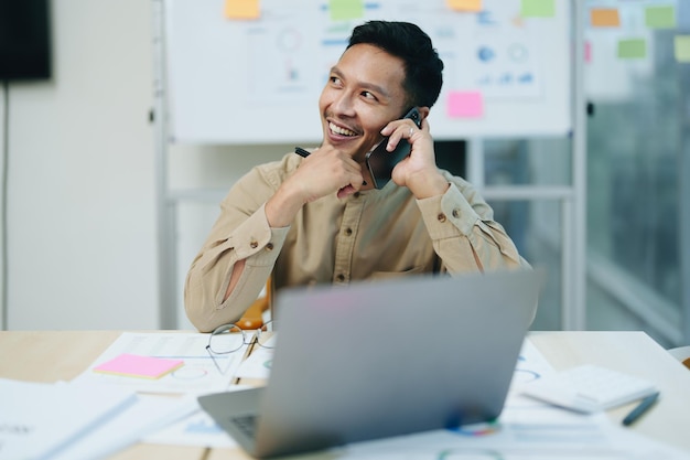 Business owner or Asian male marketers are using business phones and computers to do office work