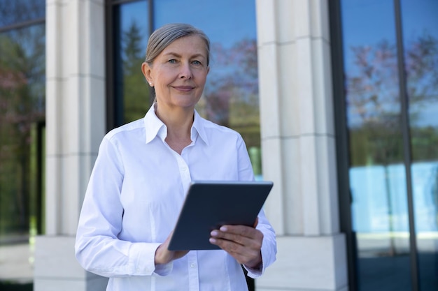 Business owner Business woman in white blouse with a laptop in hands