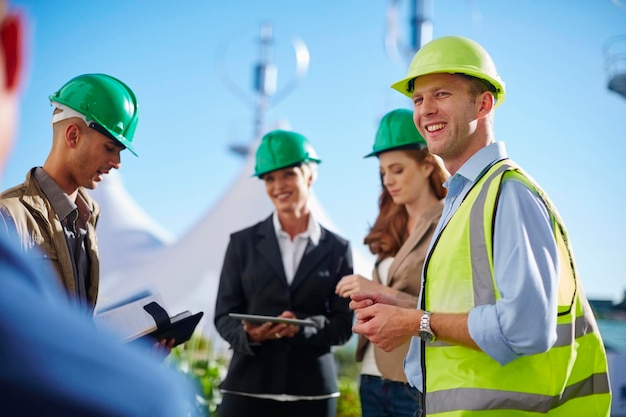 Business partners having a meeting with wind turbine engineer