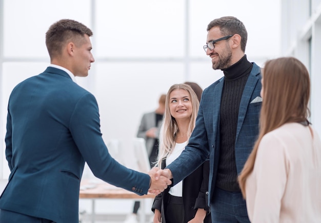 Business partners holding out their hands for a handshake