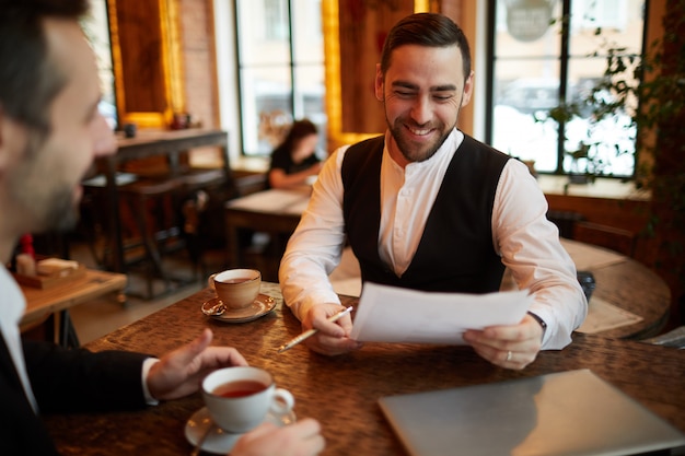 Business Partners Negotiating Deal in Restaurant