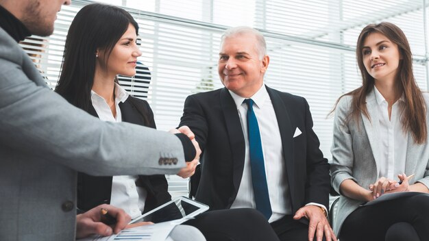 Business partners shaking hands after discussing a new contract. the concept of cooperation