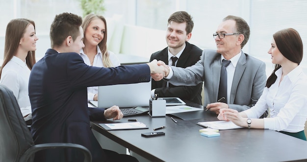 Business partners shaking hands after a successful transaction