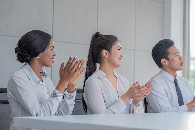 Business people applauding in meeting room or seminar