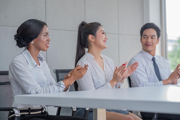 Business people applauding in meeting room or seminar