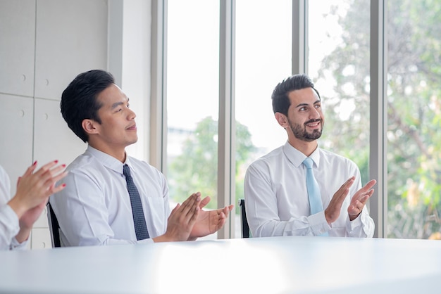 Business people applauding in a meeting room or seminar