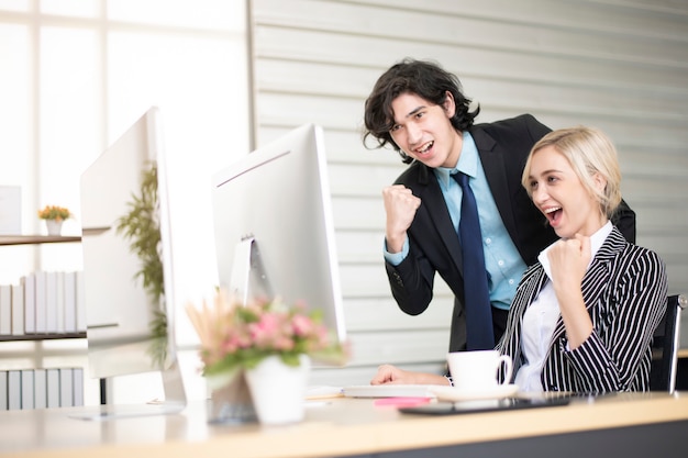 Business people are happy with business success in office 