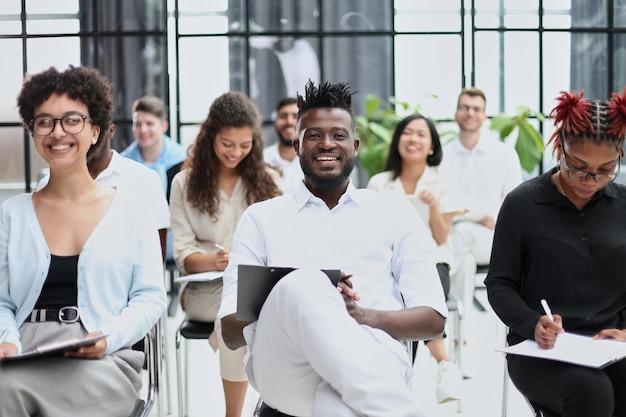 Business people attending a seminar in board room