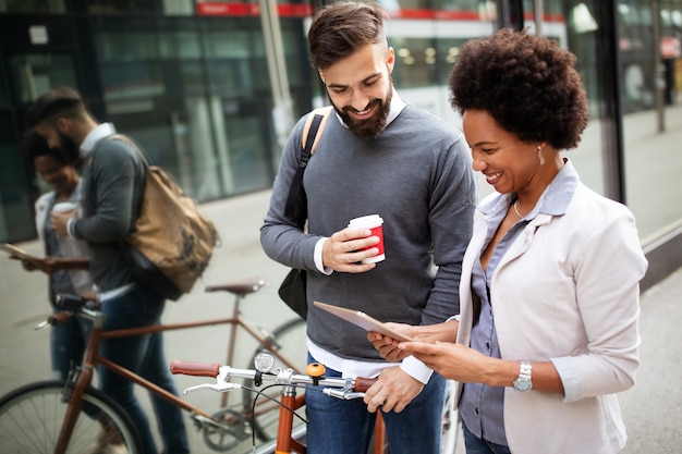 Business people on coffee break using digital tablet outdoor in city