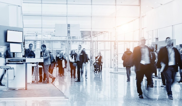 business people crowd walking in a modern hall at a trade show. ideal for websites and magazines layouts