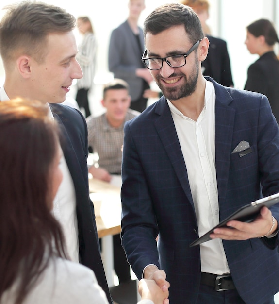 Business people greet each other in the office