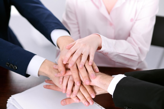 Business people group joining hands and representing concept of friendship and teamwork