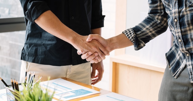 Business people handshake for teamwork of business merger and acquisition