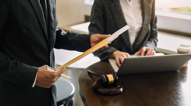 Business people and lawyers discussing contract papers sitting at the table Concepts of law advice legal services in morning light