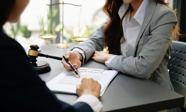 Business people and lawyers discussing contract papers sitting at the table Concepts of law advice legal services