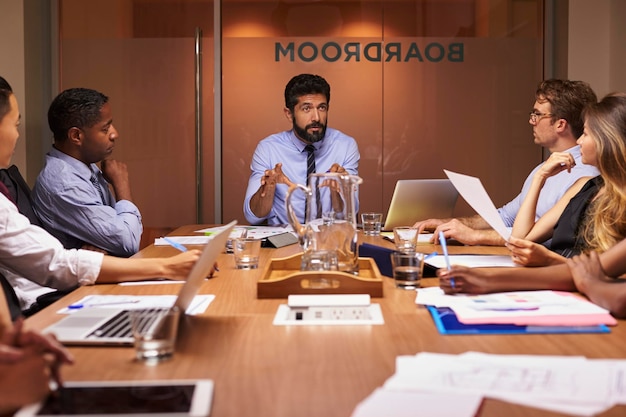 Business people listening to manager at a meeting close up