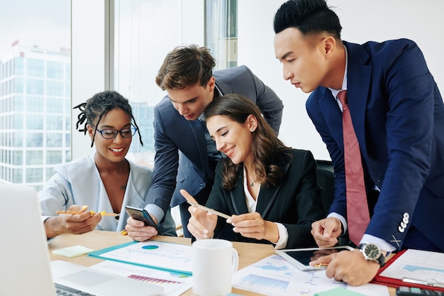 Business people looking smartphone screen