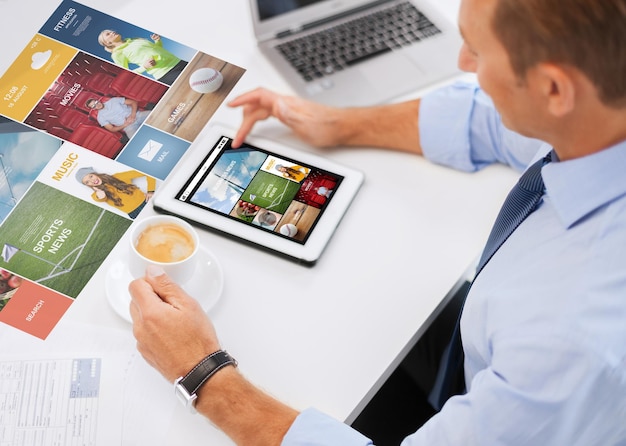 business, people, mass media and technology concept - businessman with tablet pc reading internet news and drinking coffee in office