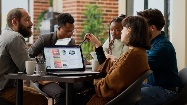 Business people meeting in boardroom to talk about presentation, analyzing data research on laptop and tablet. Colleagues working on project report, doing teamwork collaboration.