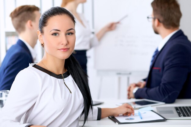 Photo business people at a meeting in the office. focus on boss woman.